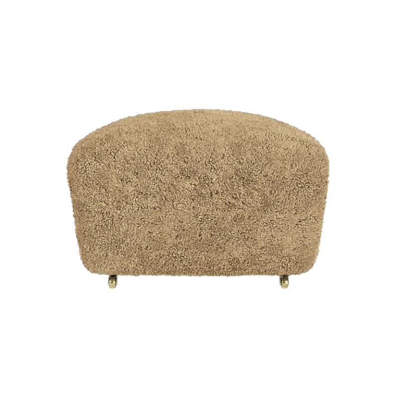 The Tired Man Sheepskin Ottoman from Audo Copenhagen in honey with dark stained oak legs from the front.
