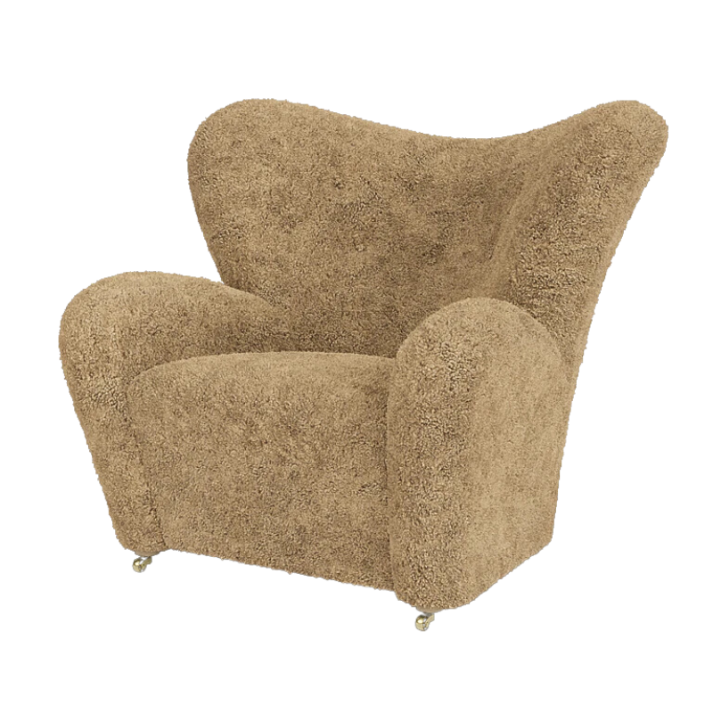 The Tired Man Sheepskin Lounge Chair from Audo Copenhagen in honey with natural oak legs.