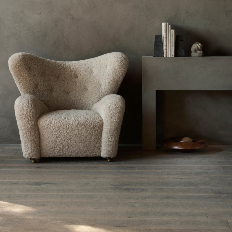 The Tired Man Sheepskin Lounge Chair from Audo Copenhagen in a living room.