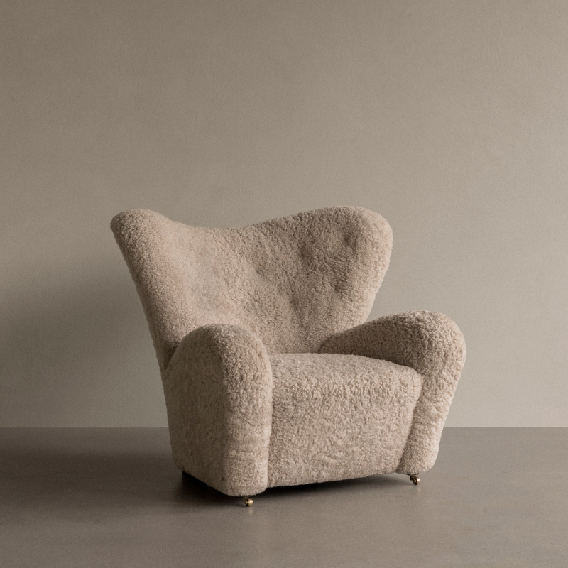 The Tired Man Sheepskin Lounge Chair from Audo Copenhagen in a studio.