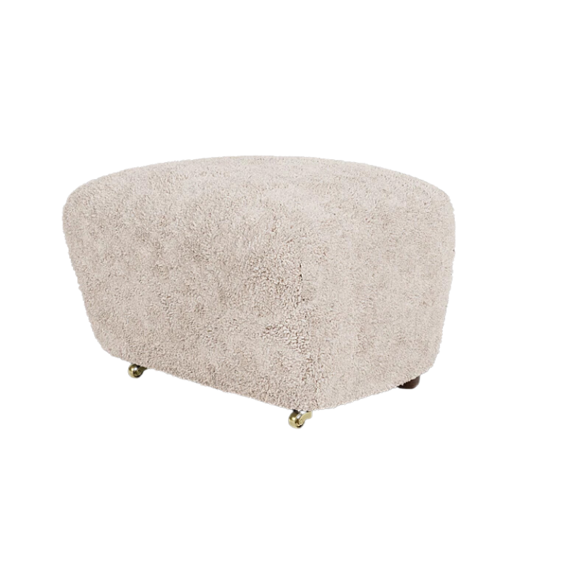 The Tired Man Sheepskin Ottoman from Audo Copenhagen in moonlight with dark stained oak legs corner.