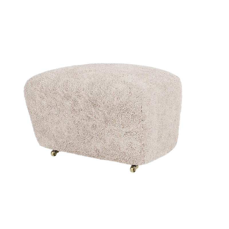The Tired Man Sheepskin Ottoman from Audo Copenhagen in moonlight with dark stained oak legs.