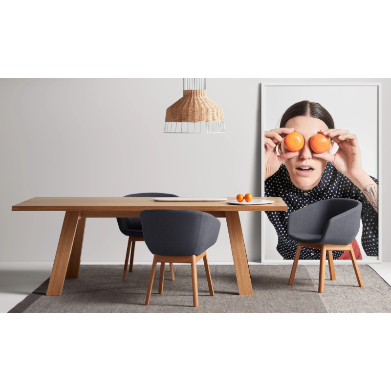 The A Walk in the Park Dining Table from Blu Dot in walnut in a living room.