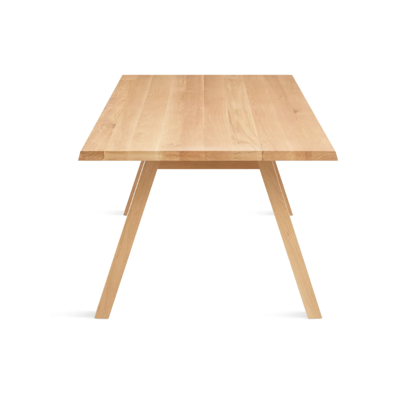 The 72 inch A Walk in the Park Dining Table from Blu Dot in white oak from the side at an angle.