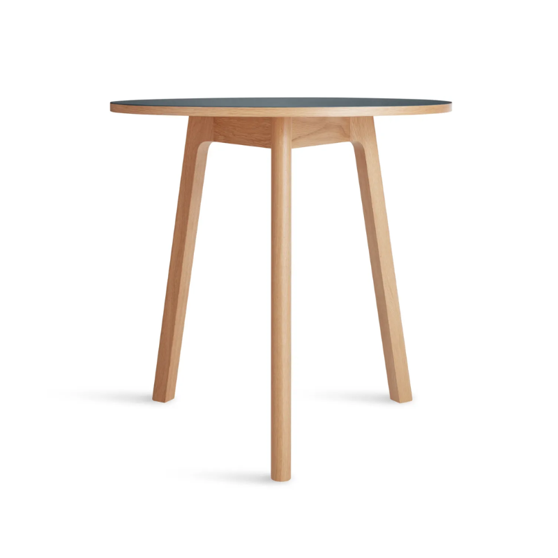 The 30 inch Apt Café Table from Blu Dot with navy green table top and white oak body from an angle.
