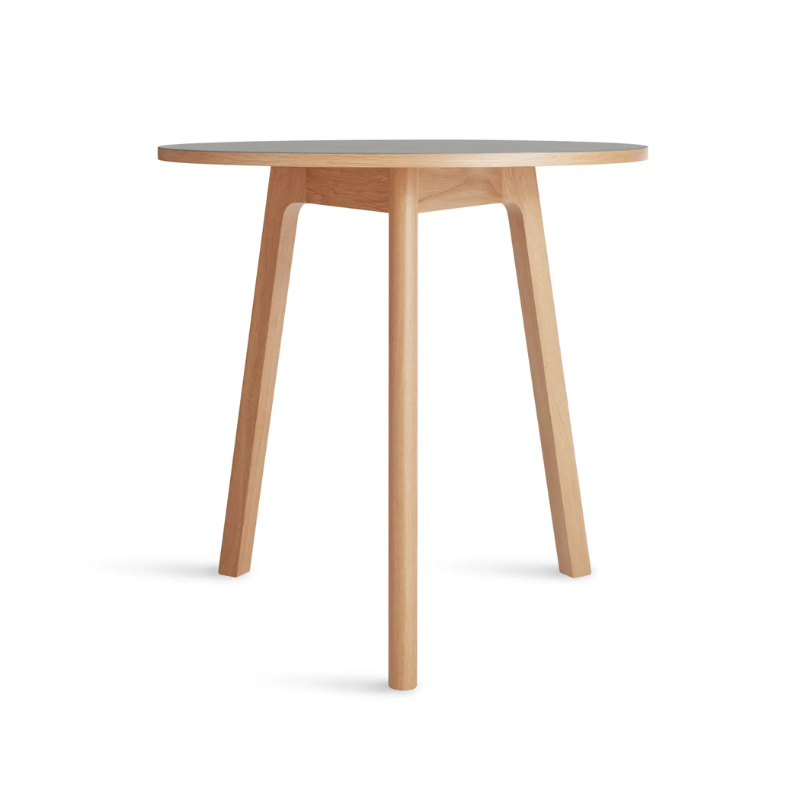 The 30 inch Apt Café Table from Blu Dot with putty table top and white oak body from the side.