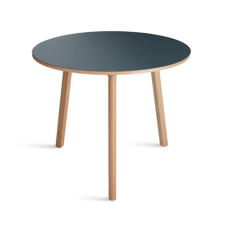 The 36 inch Apt Café Table from Blu Dot with navy green table top and white oak body in a view from the top.