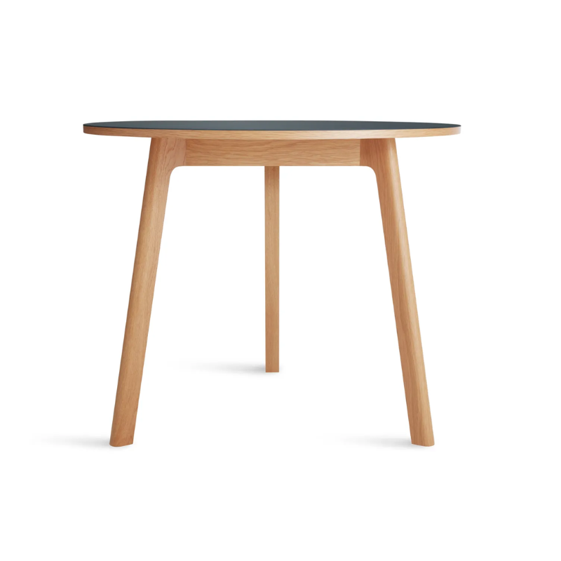 The 36 inch Apt Café Table from Blu Dot with navy green table top and white oak body.
