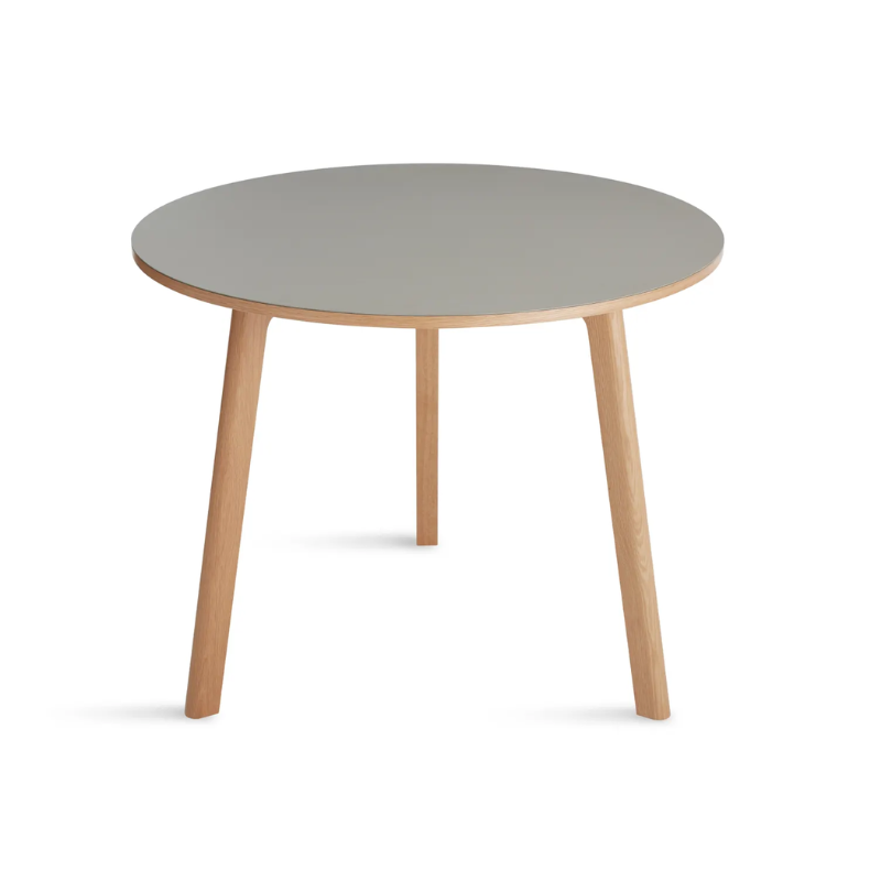 The 36 inch Apt Café Table from Blu Dot with putty table top and white oak body from an angle.