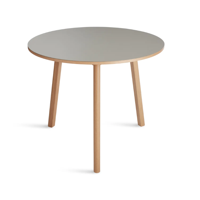 The 36 inch Apt Café Table from Blu Dot with putty table top and white oak body from a high angle.