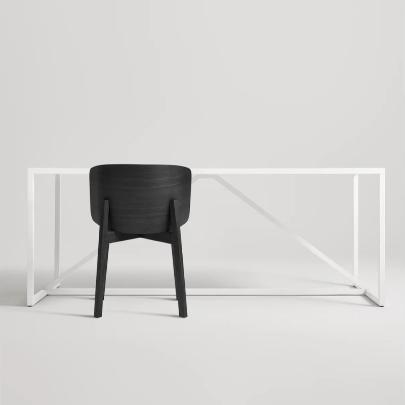 The Buddy Chair from Blu Dot in black on ash in a studio.