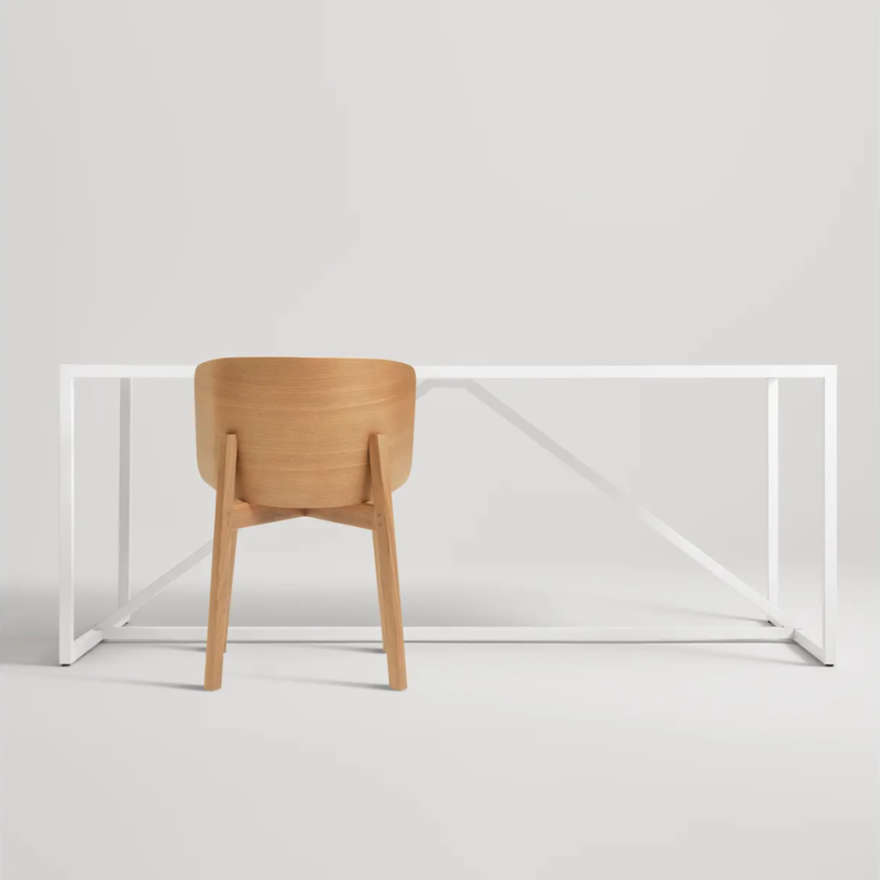 The Buddy Chair from Blu Dot in white oak in a studio.