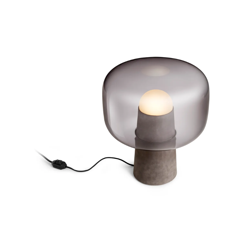 The Bully Table Lamp from Blu Dot lit from a top view.