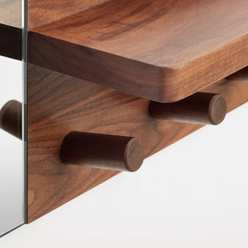 The Candid Wall Shelf with Hooks from Blu Dot in walnut close up.