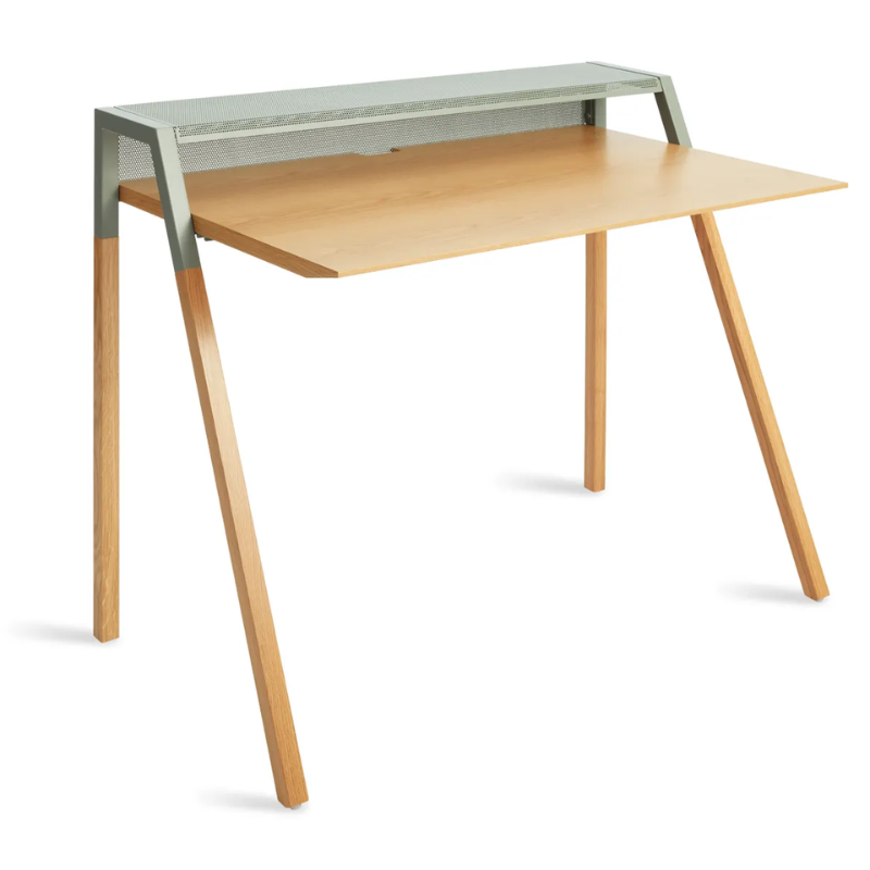 The Cant Desk from Blu Dot with white oak body and grey green back from a high angle.