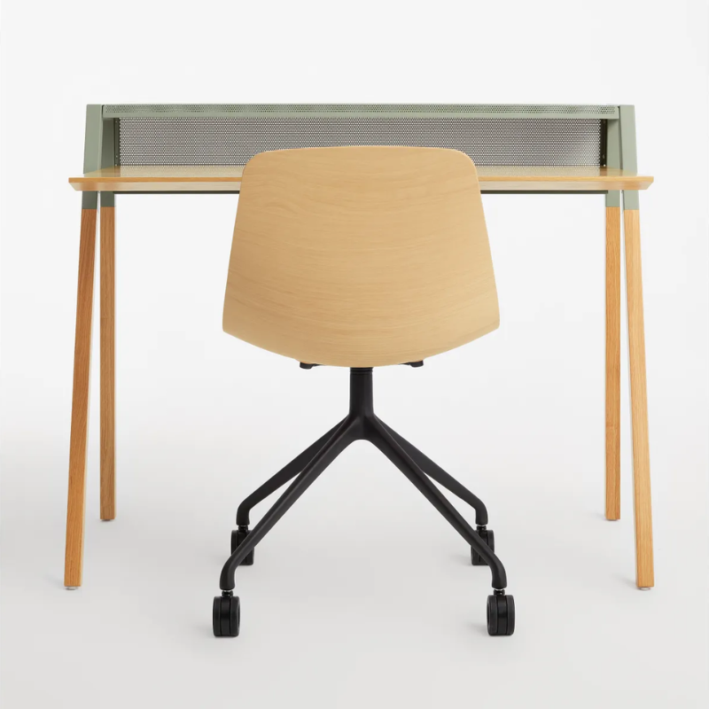 The Cant Desk from Blu Dot with white oak body and grey green back in a living room studio.
