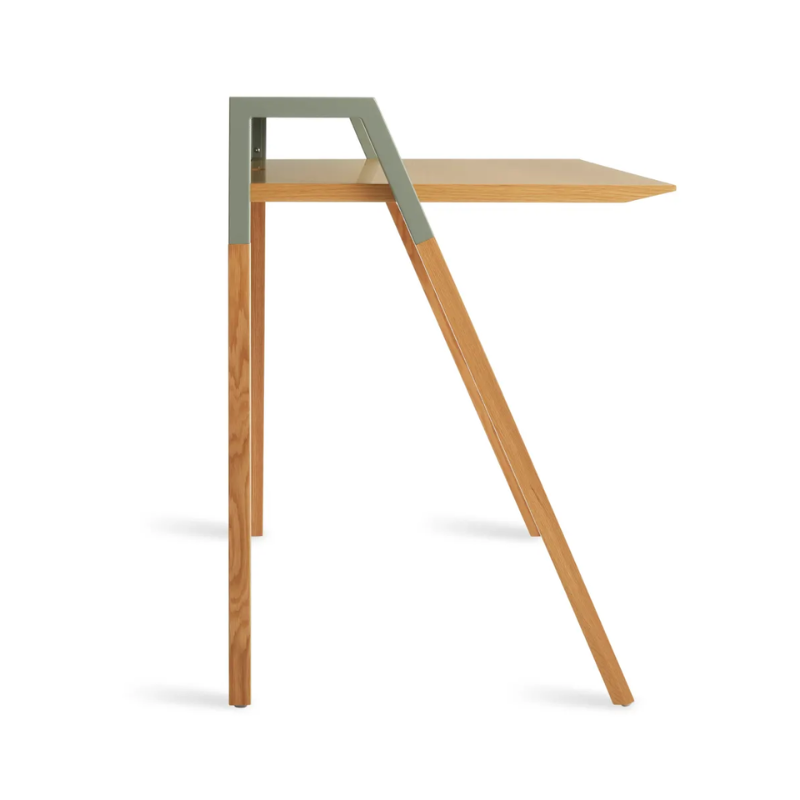 The Cant Desk from Blu Dot with white oak body and grey green back from the side.