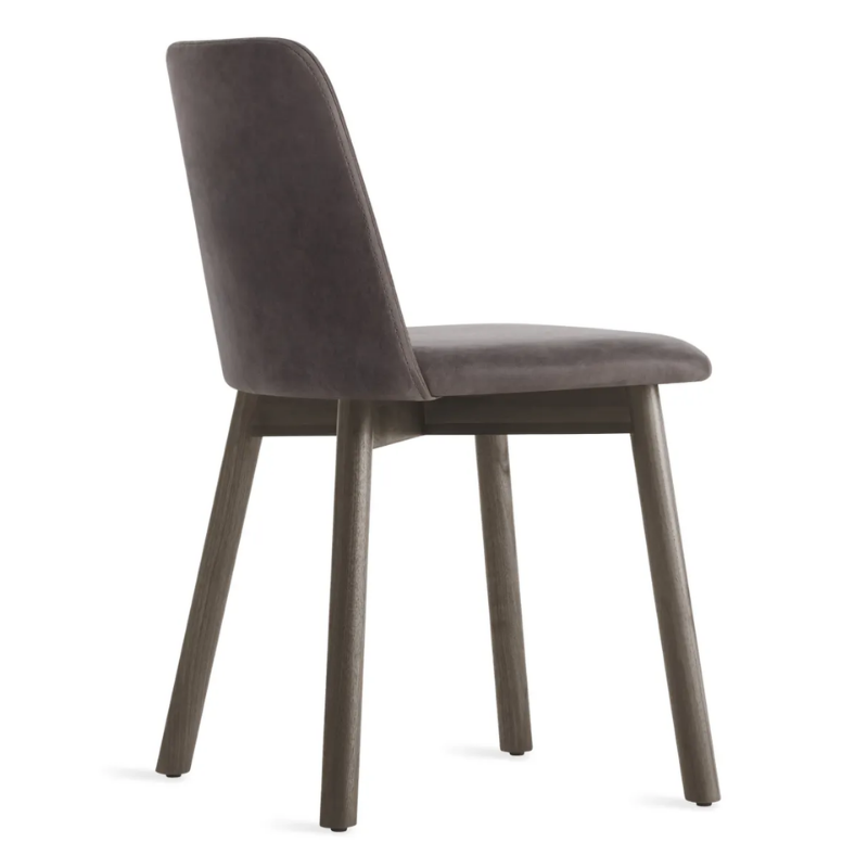 The Chip Chair from Blu Dot with smoke legs and slate leather upholstery from the back at an angle.