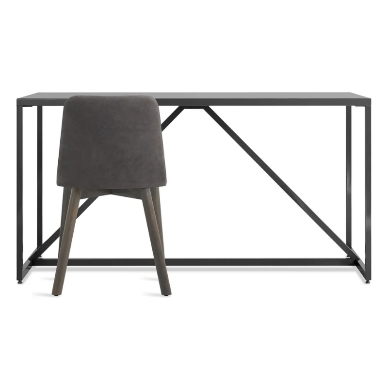 The Chip Chair from Blu Dot with smoke legs and slate leather upholstery in a studio.