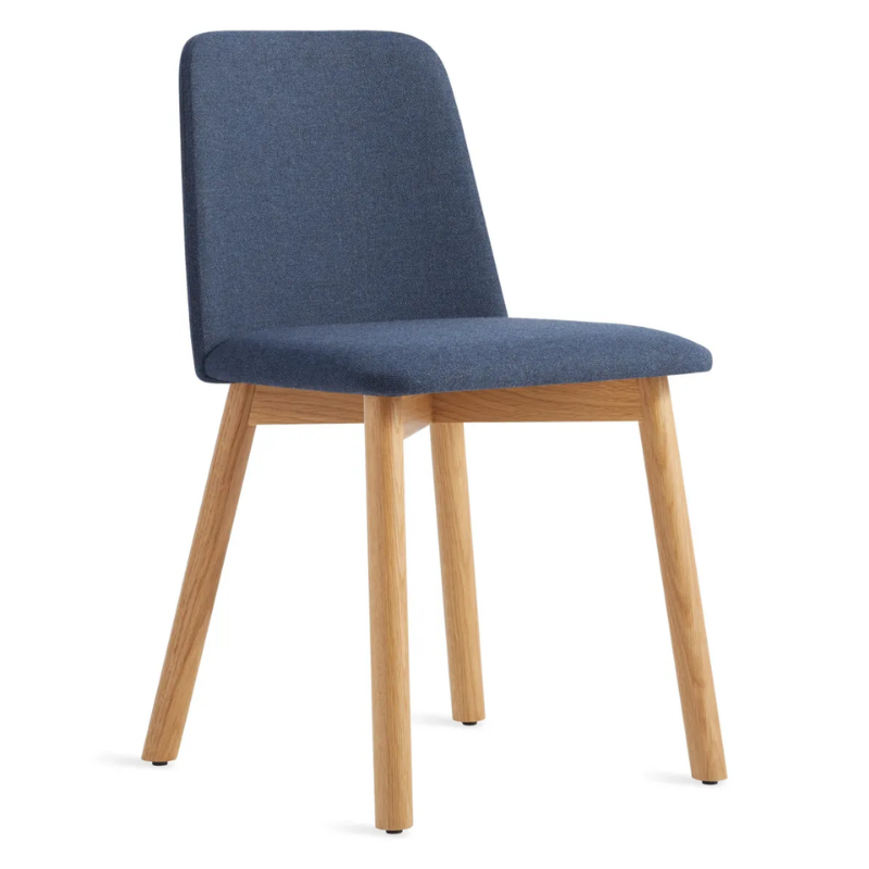 The Chip Chair from Blu Dot with white oak legs and toohey navy upholstery from an angle.