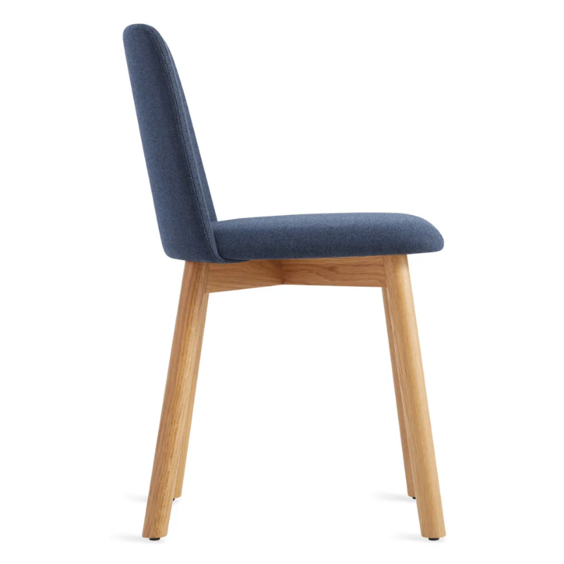The Chip Chair from Blu Dot with white oak legs and toohey navy upholstery from the side.