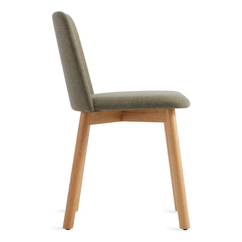 The Chip Chair from Blu Dot with white oak legs and toohey olive upholstery from the side.