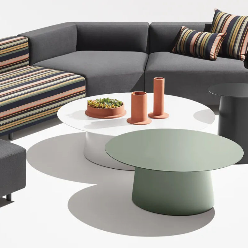 The Circula Low Side Table from Blu Dot in grey green in a living room.