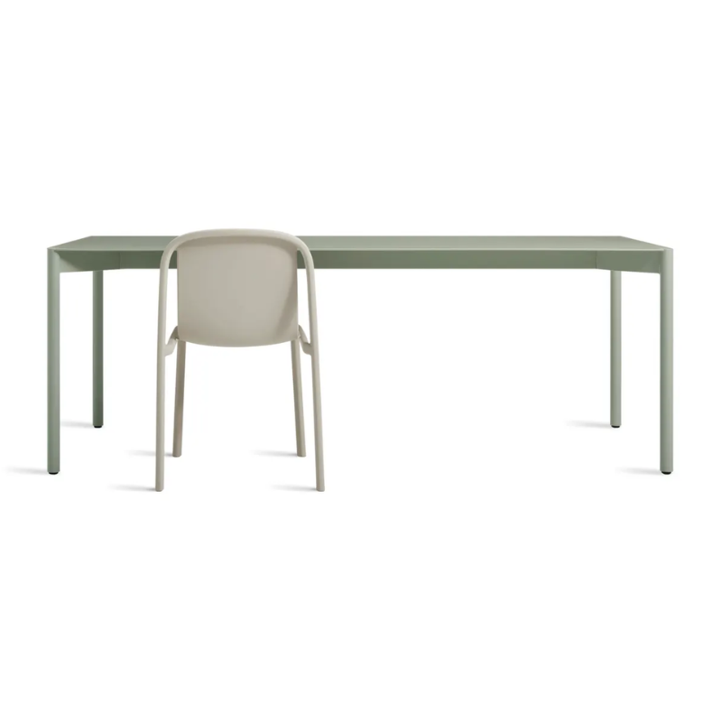 The Comeuppance Dining Table from Blu Dot in grey green in a dining room.