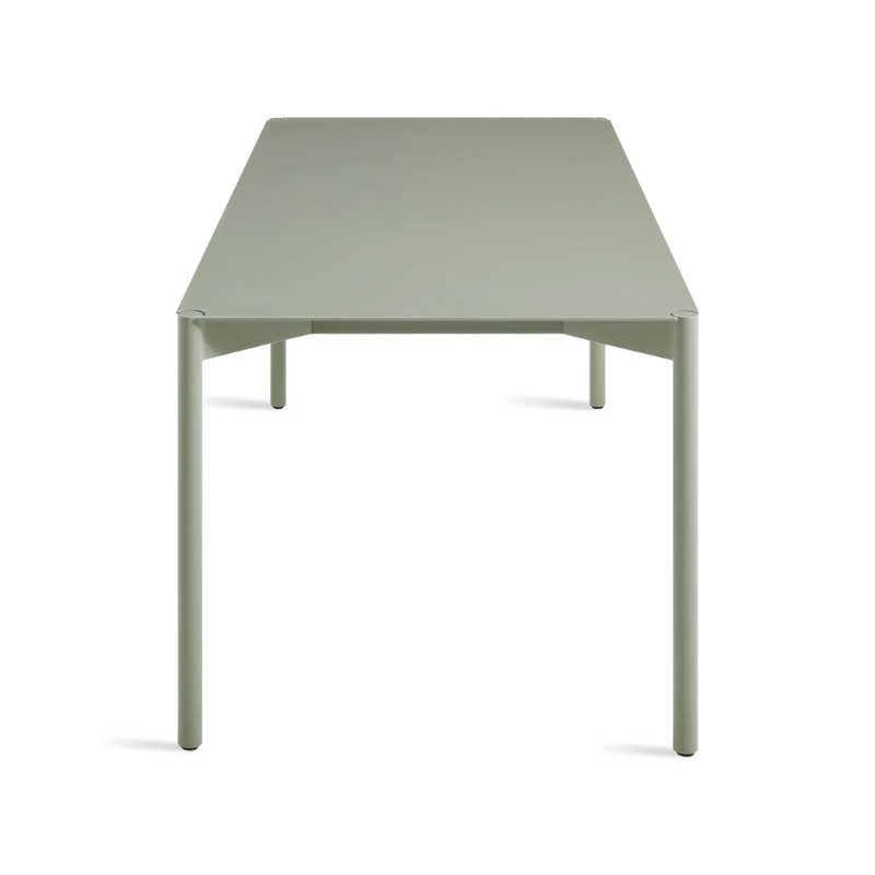 The Comeuppance Dining Table from Blu Dot in grey green from the side at an angle.
