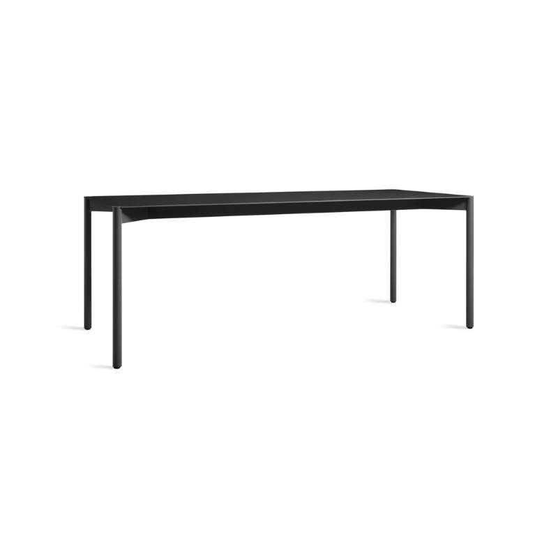 The Comeuppance Dining Table from Blu Dot in oblivion from an angle.