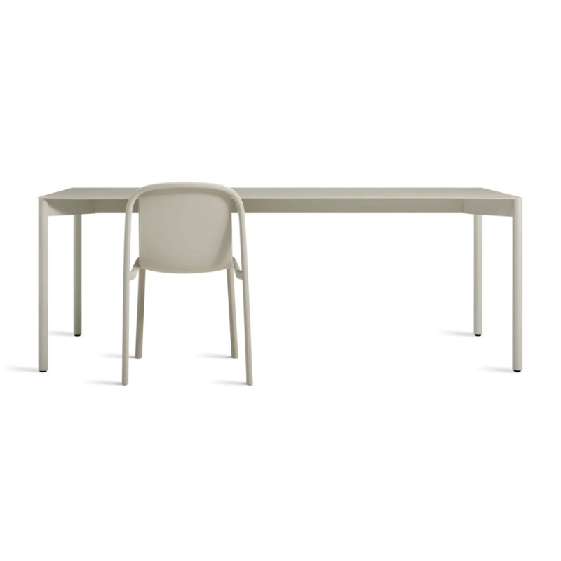 The Comeuppance Dining Table from Blu Dot in putty in a family room.