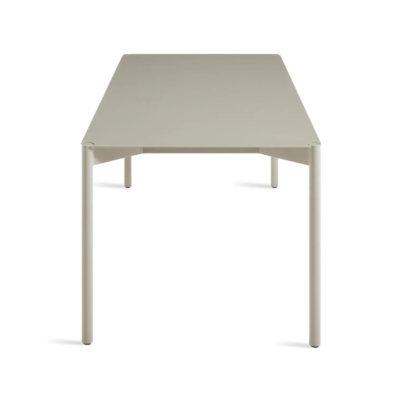 The Comeuppance Dining Table from Blu Dot in putty from the side at an angle.