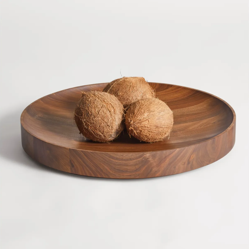 The Cusp Large Bowl from Blu Dot in walnut in a kitchen and dining setting.
