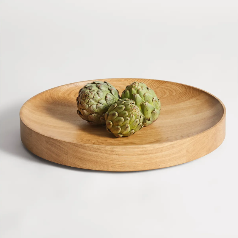 The Cusp Large Bowl from Blu Dot in white oak in a family room.