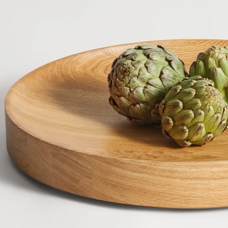 The Cusp Large Bowl from Blu Dot in white oak in a living room studio.