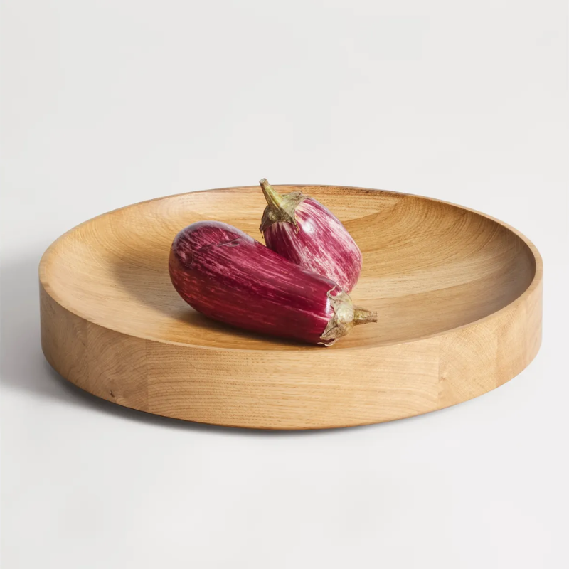 The Cusp Medium Bowl from Blu Dot in white oak in a living room.