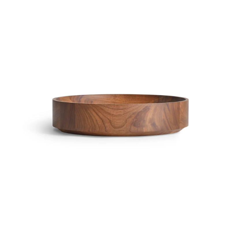 The Cusp Small Bowl from Blu Dot in walnut from an angle.