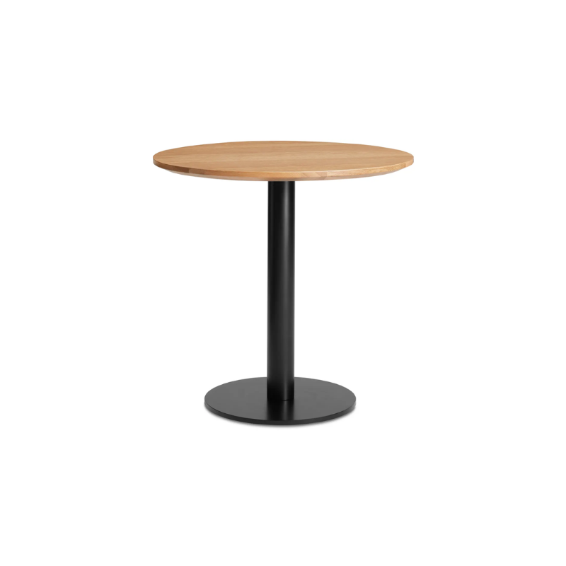 The 30 inch round Easy Dining Table from Blu Dot with a white oak top and black base from an angle.