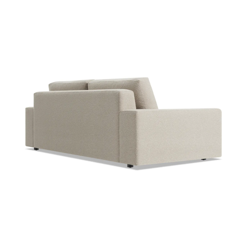 The 82 inch Esker Sofa from Blu Dot in Kelso sand from the back at an angle.