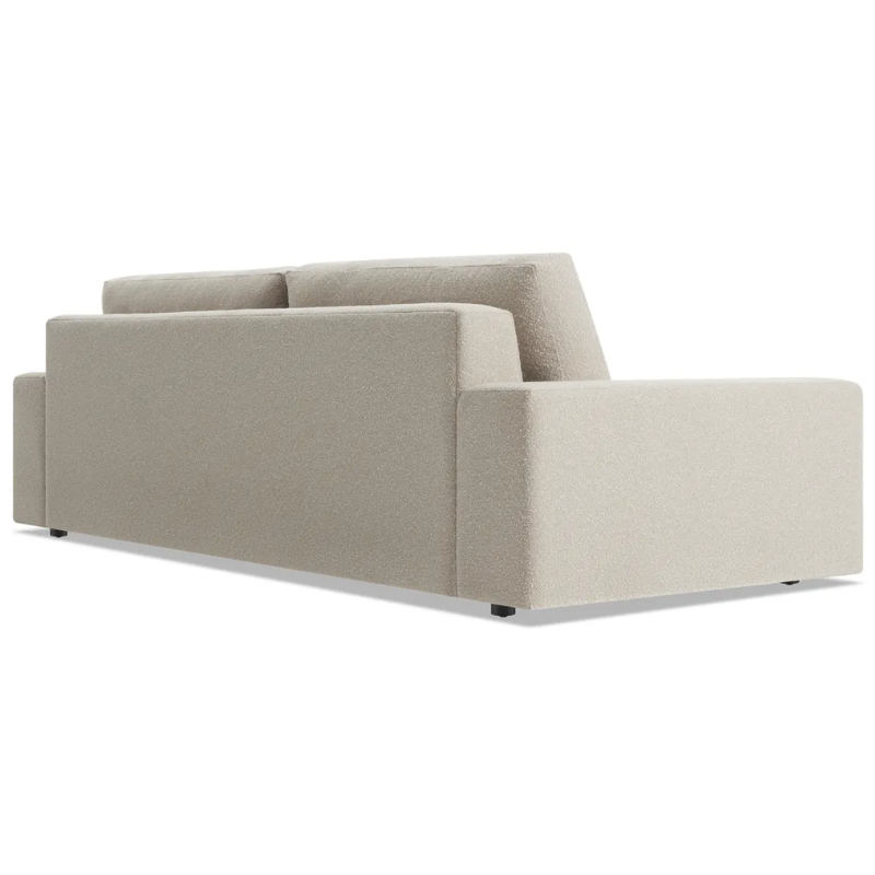 The 98 inch Esker Sofa from Blu Dot in Kelso sand from the back at an angle.