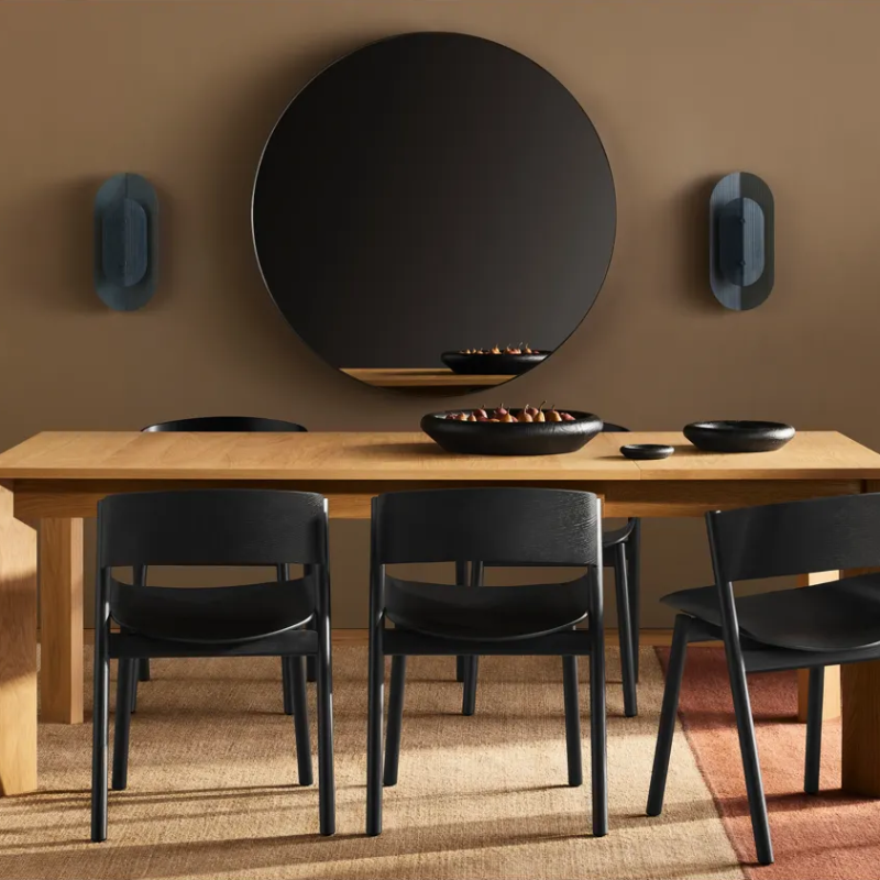 The Filter Sconce from Blu Dot in marine blue in a dining room.