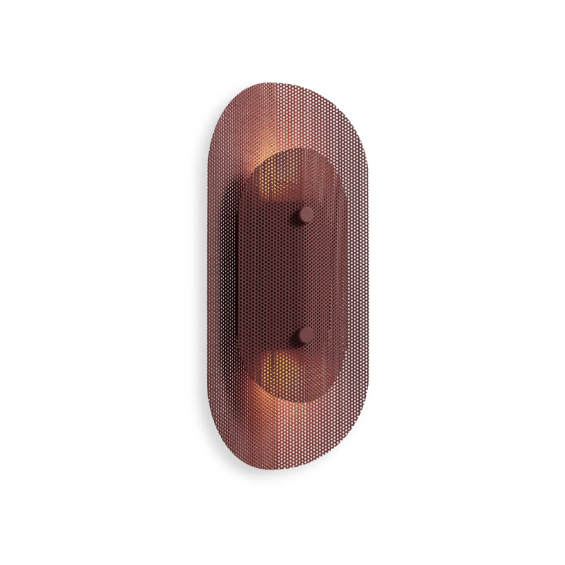 The Filter Sconce from Blu Dot in oxblood from an angle turned on.