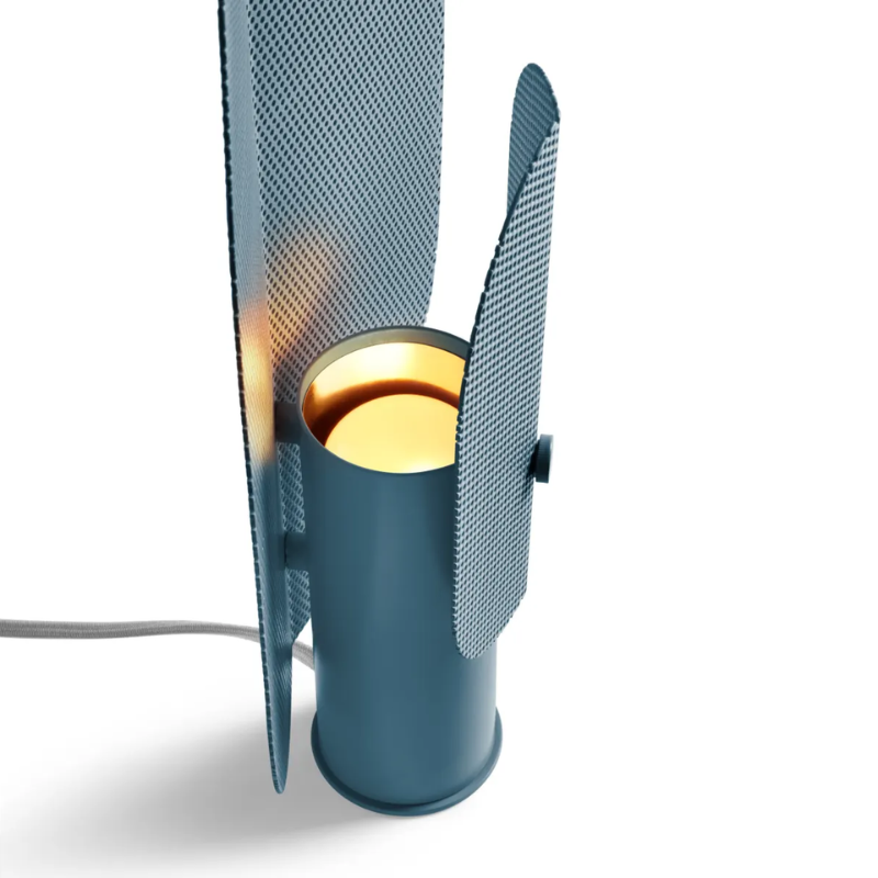 The Filter Table Lamp from Blu Dot in marine blue focusing on the light bulb turned on.