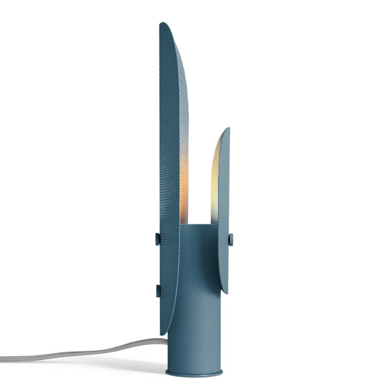 The Filter Table Lamp from Blu Dot in marine blue from the side lit.
