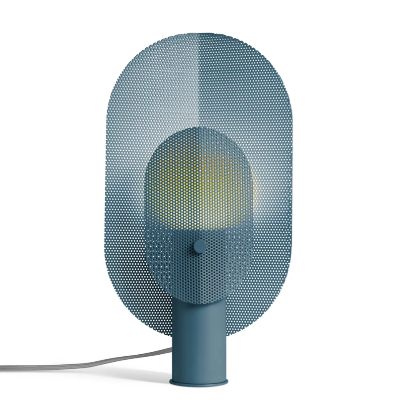 The Filter Table Lamp from Blu Dot in marine blue turned on.