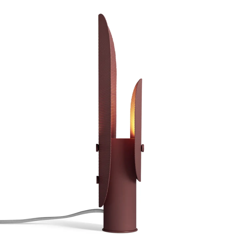 The Filter Table Lamp from Blu Dot in oxblood from the side lit.