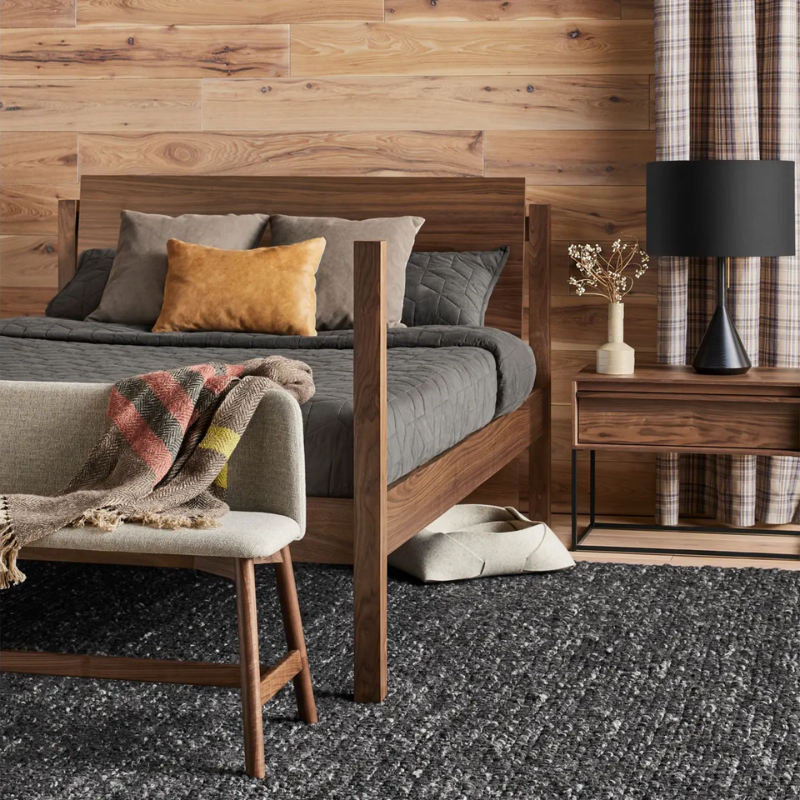 The Flask Table Lamp from Blu Dot in black in a primary bedroom.