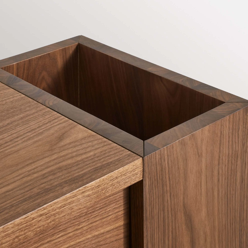 The Go Forth Bench from Blu Dot in walnut focusing on the storage in detail.