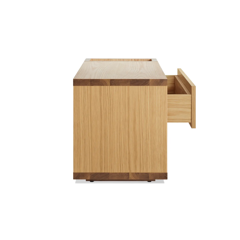 The Go Forth Bench from Blu Dot in white oak from the side with an open drawer.