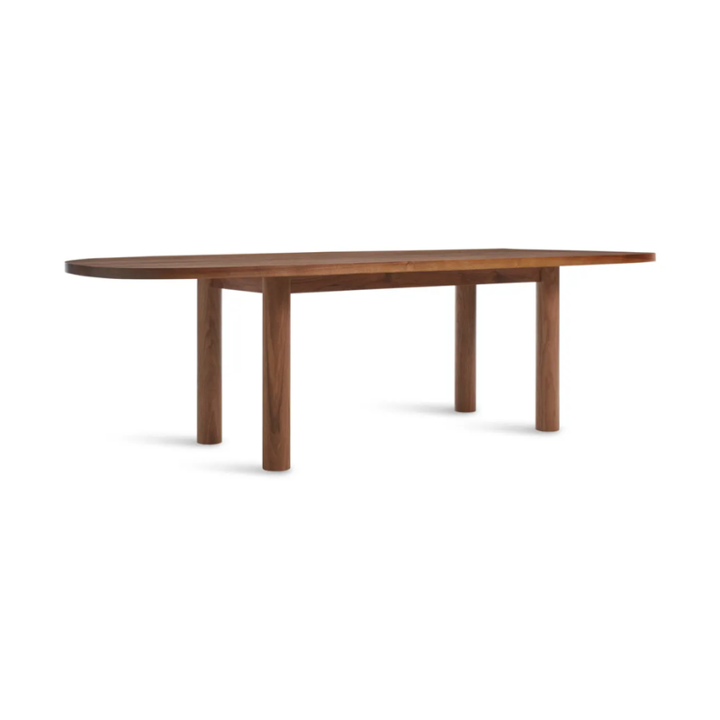The 100 inch Good Times Dining Table from Blu Dot in walnut from an angle.